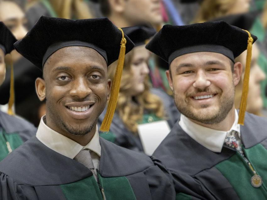 Magazine cover photo of two smiling graduates