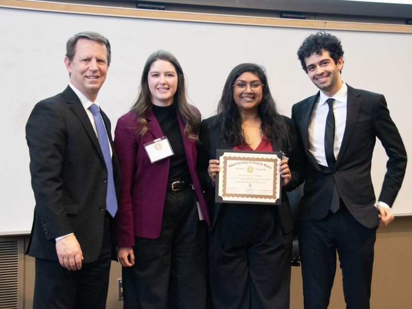 Students and faculty on Research Day posing with an award winner