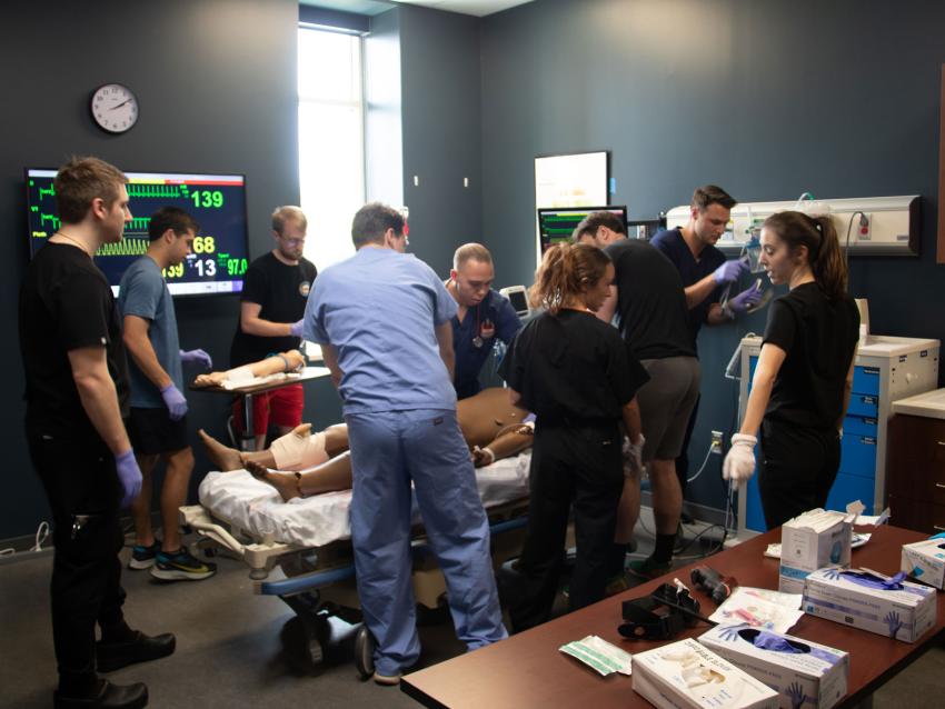 VCOM-Carolinas students in a simulation room working
