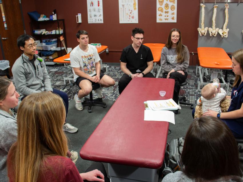 VCOM-Carolinas students sitting in a circle discussion