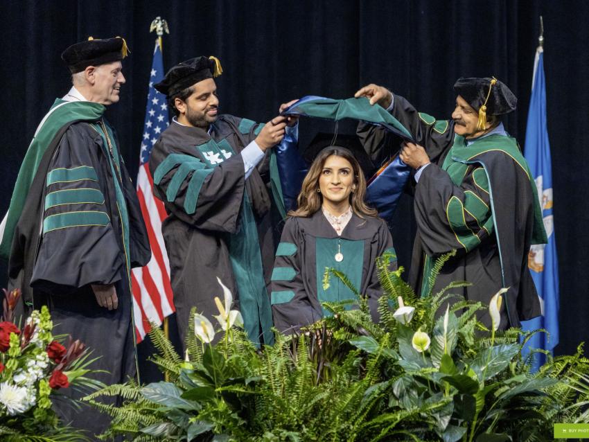 VCOM-Louisiana student being hooded by her family of doctors
