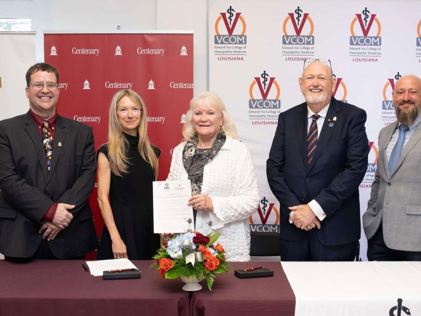 Centenary College and VCOM members smiling and holding signed articulation agreement