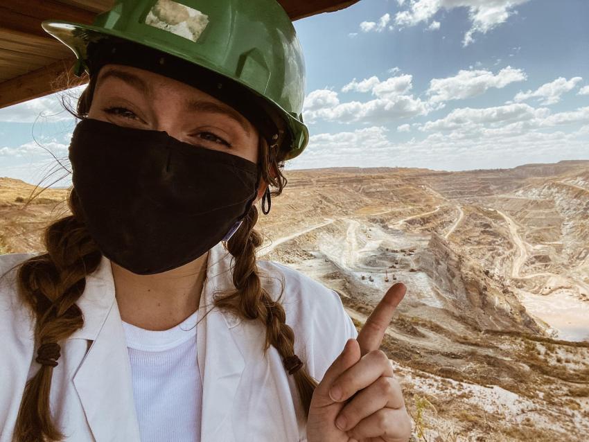 Abby Logan in a mask overlooking a mining site