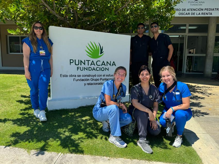 VCOM-Louisiana students posing in front of the Punta Cana clinic sign