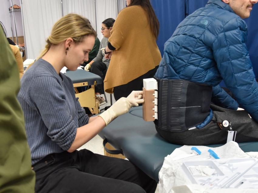 Student practicing epidural in simulation center