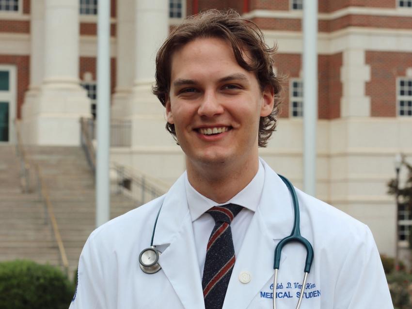 Caleb Van Horn in white coat smiling