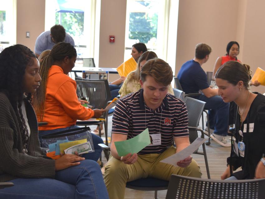 VCOM-Auburn students sitting in a circle talking