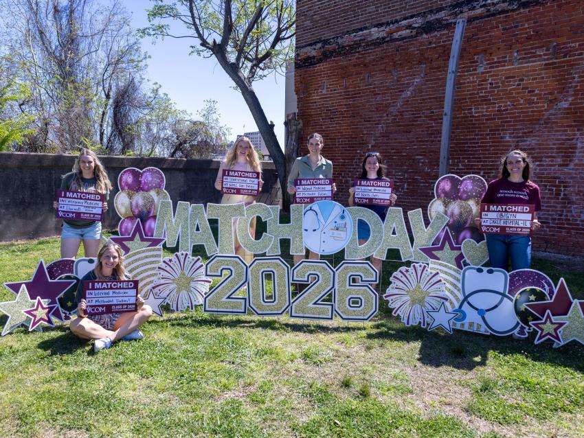 VCOM-Louisiana class of 2026 students outside holding their match day signs