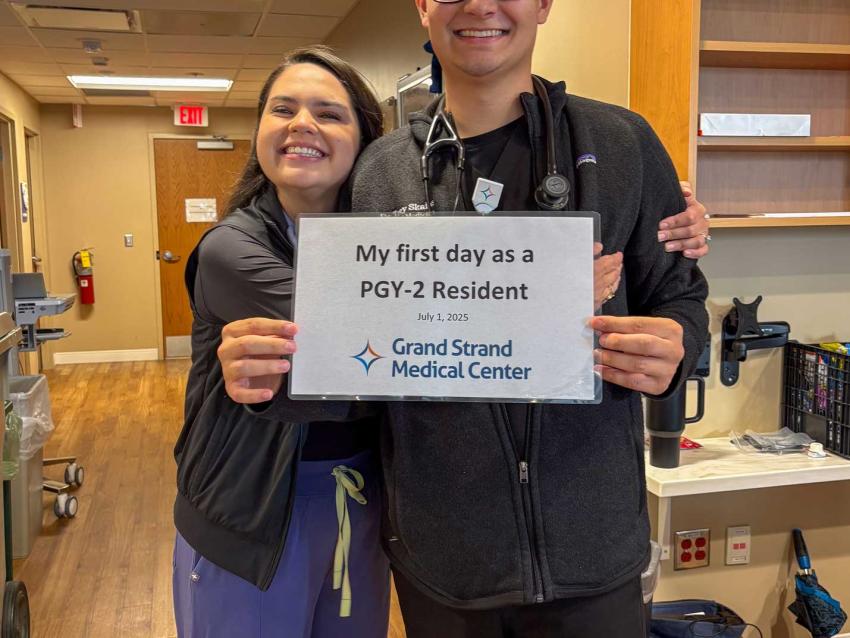 Trey Skains holding up his hospital match sign