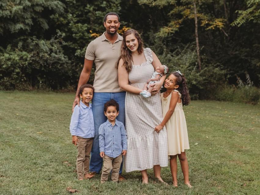 Jordan Saunders with his wife and children outside smiling