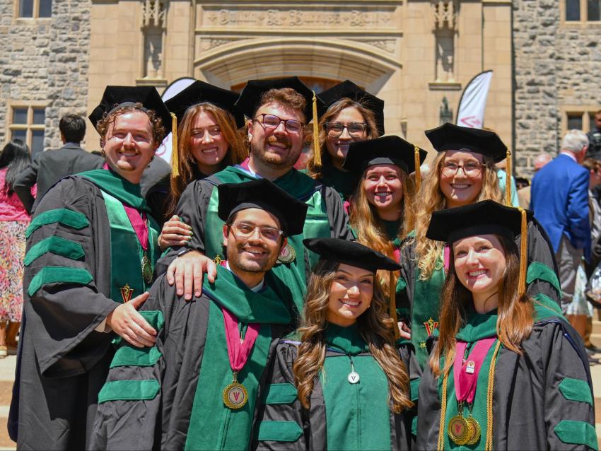 Large group of VCOM-Virginia 2026 graduates in regalia smiling