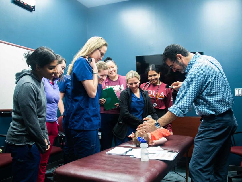 Dr. Sahhar with students during a pediatric bootcamp