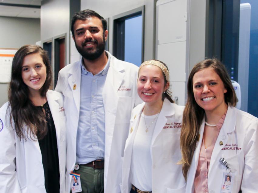 VCOM students in white coats