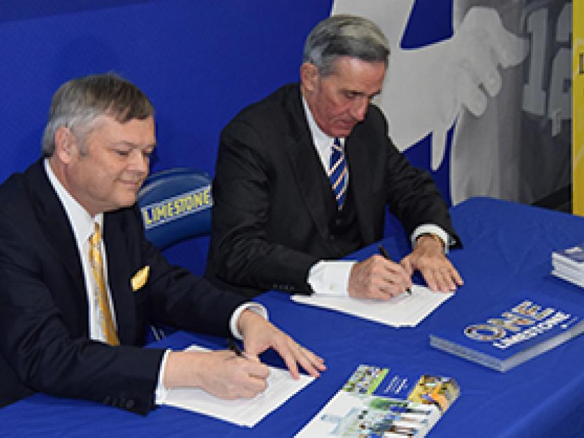 John G. Rocovich with Limestone representative signing documents