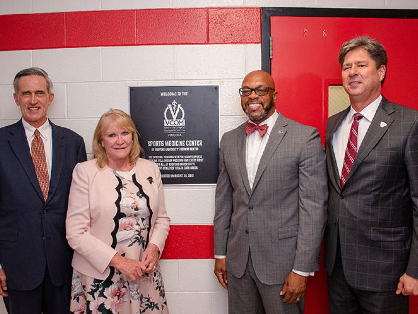 VCOM and Radford University representatives standing in front of sports medicine center