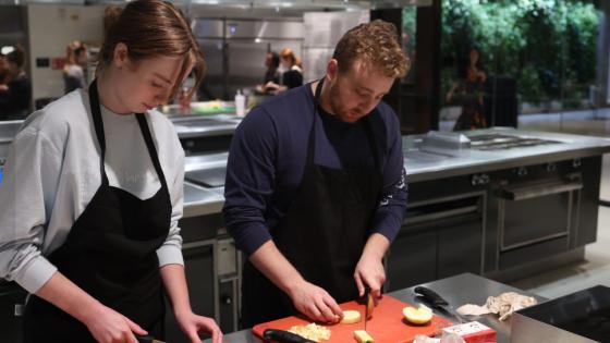 VCOM-Auburn students cutting vegetables in a kitchen