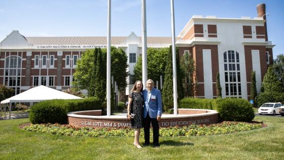 Gail Lott and James Edinger standing in front of the building displaying their name