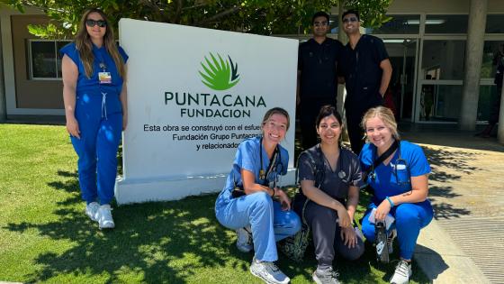 VCOM-Louisiana students posing in front of the Punta Cana clinic sign