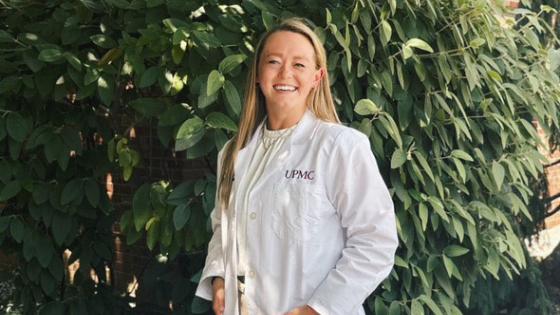 Kristina Alexander, DO smiling in her white coat