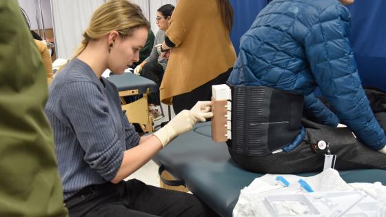 Student practicing epidural in simulation center