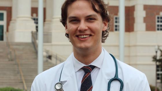 Caleb Van Horn in white coat smiling