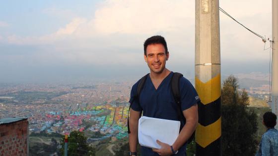 Robert Eysler on a mission trip with a view of the city behind him