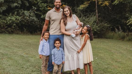 Jordan Saunders with his wife and children outside smiling