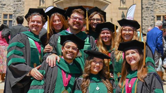 Large group of VCOM-Virginia 2026 graduates in regalia smiling
