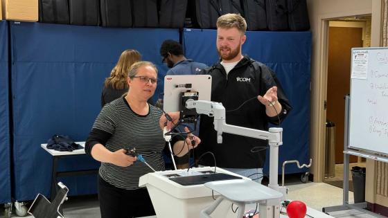 David Grace, VCOM-Virginia '28, works with a Radford University Nursing student on the laparoscopic trainer he developed.
